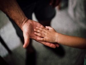 hands of child and man