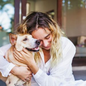 Woman hugging dog