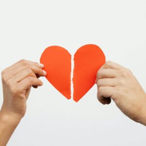 broken heart with two hands holding each half