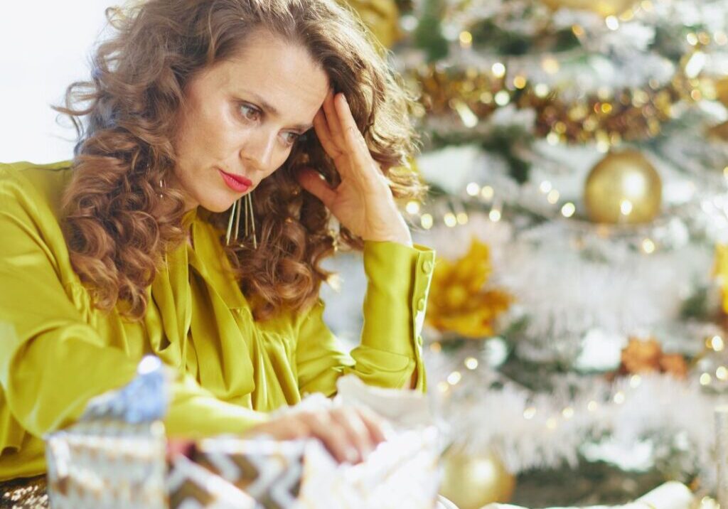 Sad woman sitting at table during holidays
