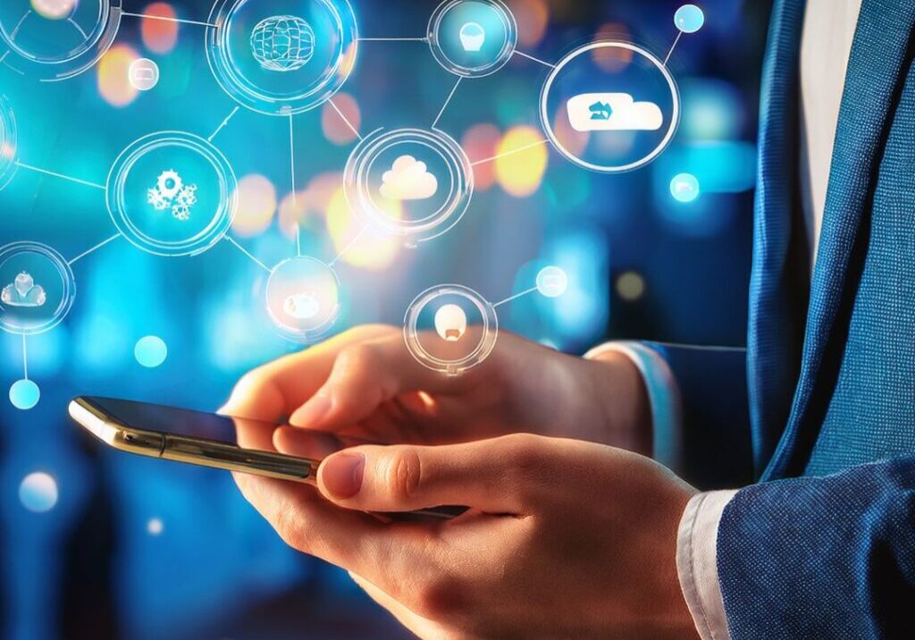 Man working on his cell phone with social media icons floating around the phone.