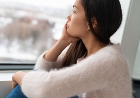Woman looking out of window