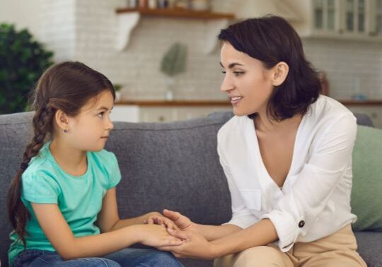 Mother talking to young daughter