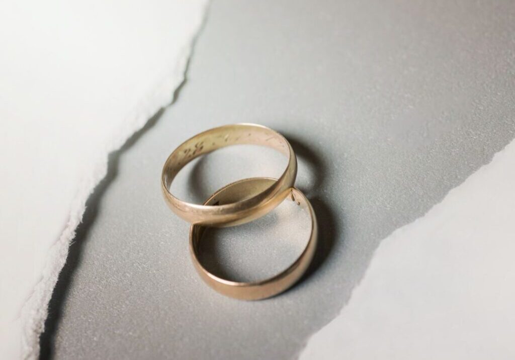 Rings laying between a torn piece of paper.